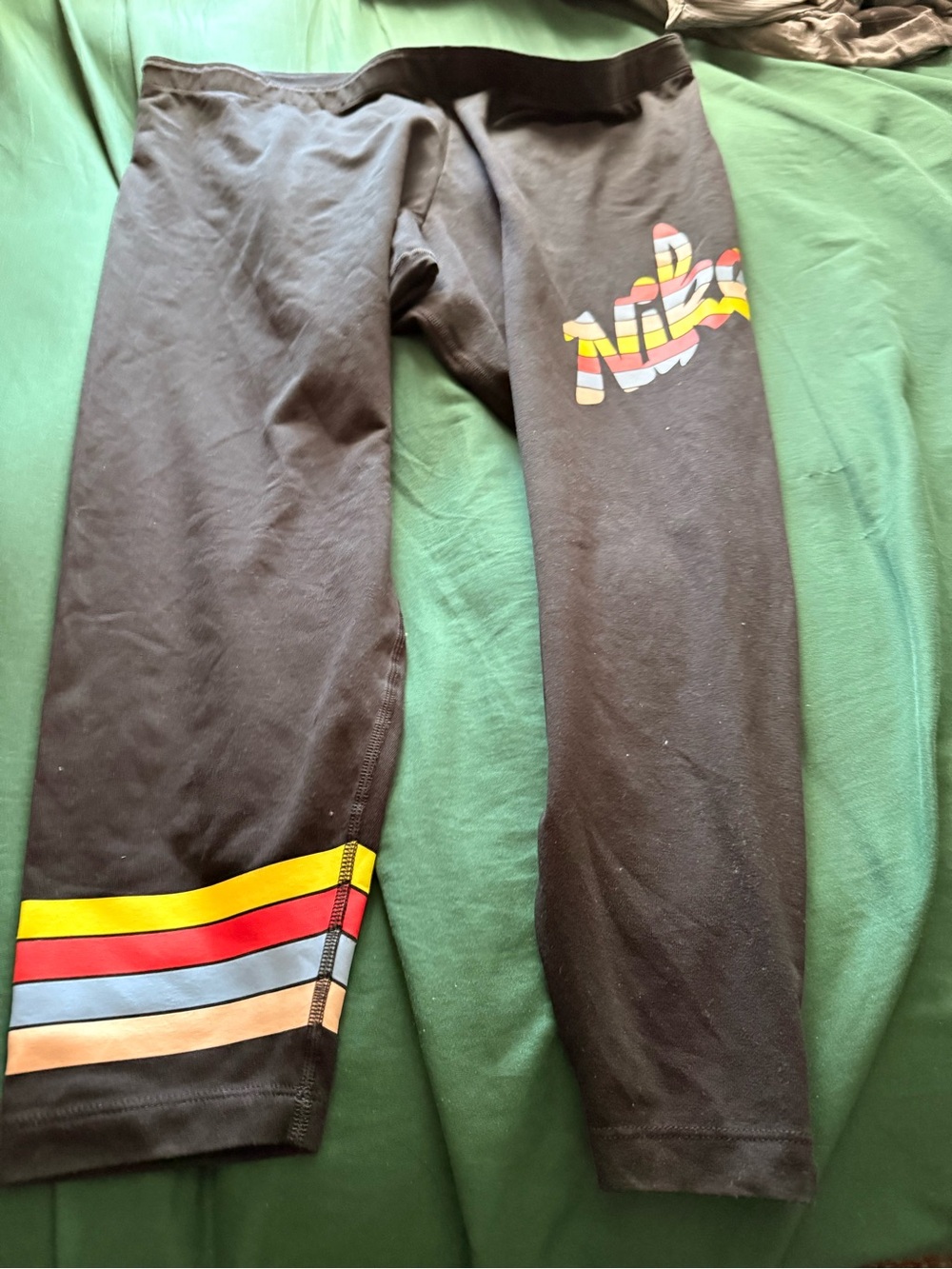Nike women’s black Capri Leggings with Multicolor Stripe Detail